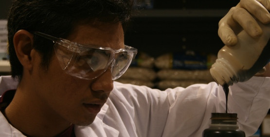 scientist poring liquid into a bottle